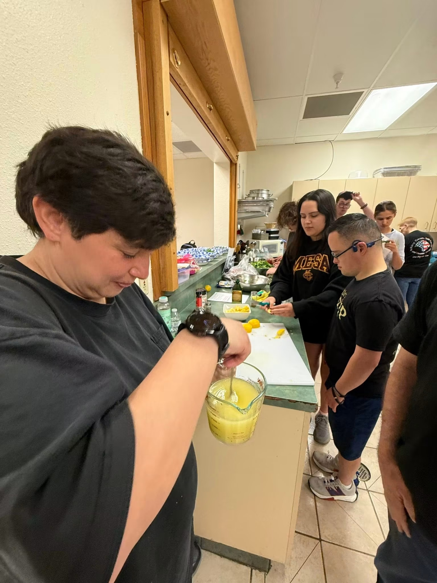 Group juicing lemons and prepping ingredients along the kitchen counter