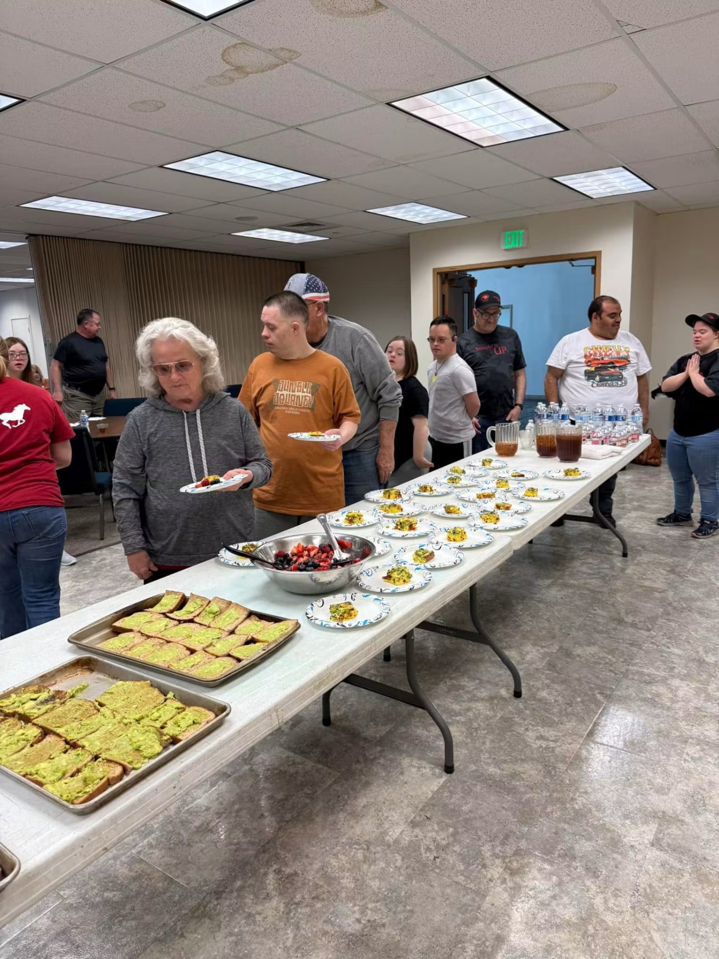 Everyone lining up to serve the meal they cooked together