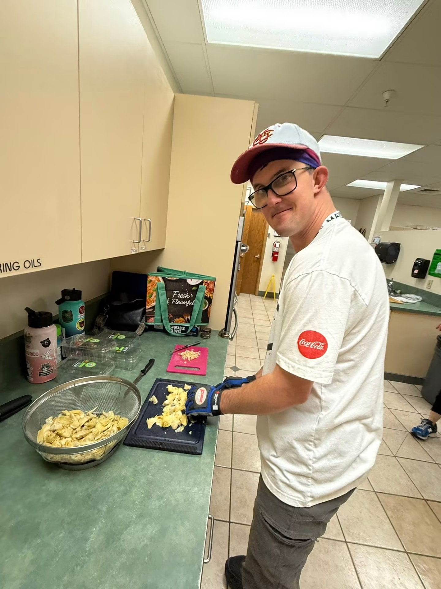 Athlete chopping cooked pasta at the prep counter