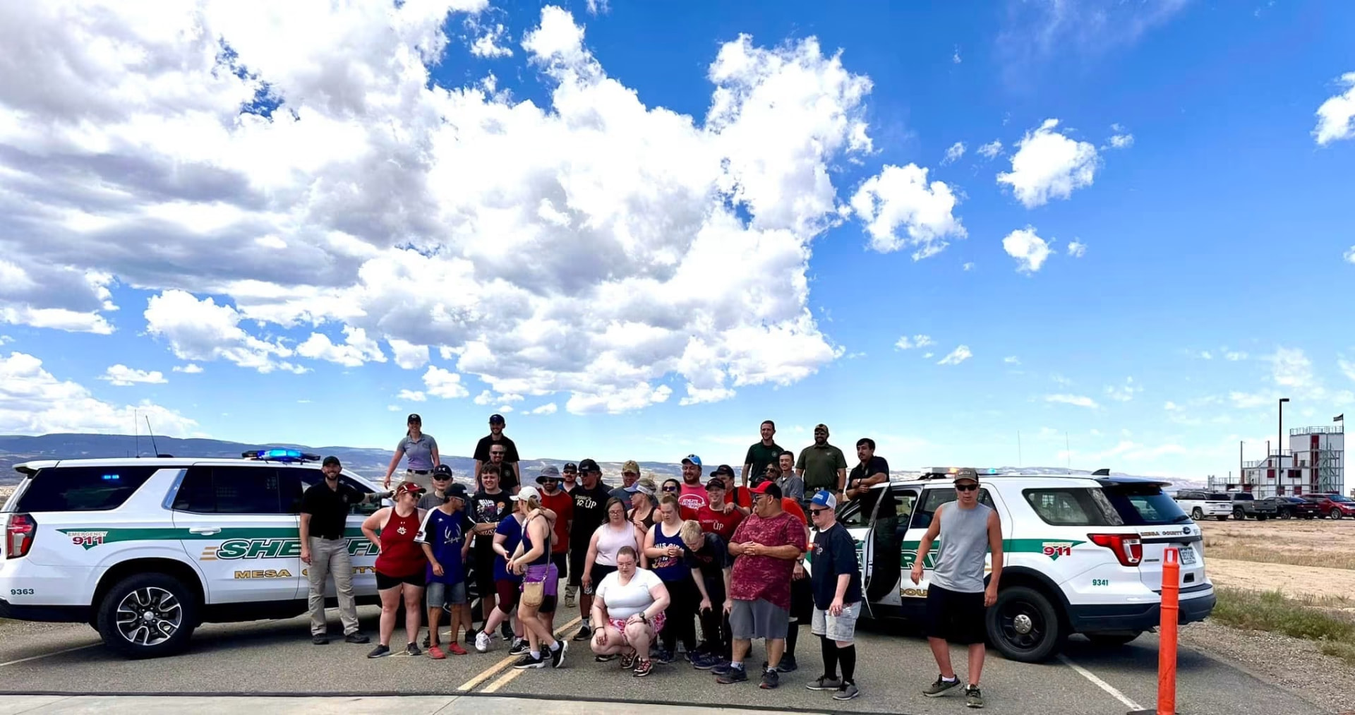 Steppin' It Up group photo with Mesa County Sheriff's Office deputies and their vehicles